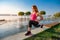 Young woman streching legs early morning before working time on outdoor