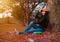 Young woman in stress situation when reading a book in park