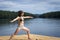 Young Woman stretching on cedar dock