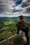 Young woman stretching looking at the view of old volcanos, adventure holidays, auvergne ,France