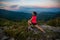 Young woman stretching after trail cross country running in mountains