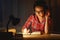 young woman student in headphones working on the computer at night