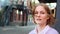 Young woman student with short fair hair waved by light wind