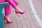 Young woman in stylish high-heeled shoes resting on bench outdoors