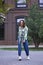 Young woman. Stylish image. Fashionable clothing jeans and sneakers. Campus.