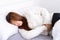 Young woman suffering stomach aches lying on the bed. Healthcare medical or daily life concept