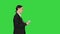 Young woman in a suit counting money on a Green Screen, Chroma Key.