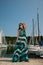 Young woman with summer dress and sunglasses walks pier of marin