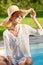 Young woman sun bathing in spa resort swiming pool