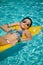 Young woman sun bathing in spa resort swiming pool