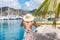 Young woman with sun hat in Philipsburg marina harbor, St Maarten, popular port of call for cruise ship travel destination.