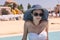 Young Woman in Sun Hat by Resort Swimming Pool