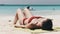 Young Woman Sunbathes on a Paradise Sandy Beach Lying in Red Swimsuit near Ocean