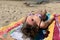 Young woman sunbathes on the sea beach close up