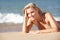 Young Woman Sunbathing On Beach