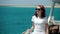 Young woman in sunglasses walk on yacht boat