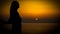 Young woman sunset silhoutte on a coast