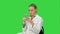 Young woman surgeon doctor reading sms on cell phone on a Green Screen, Chroma Key.