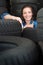 Young woman surrounded by car tyres