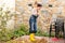 Young woman sweeping autumn leaves veranda