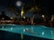 Young woman swimming. Beautiful night pool