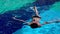 Young woman swimming in a blue pool