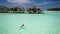 Young woman swimming in a coral lagoon