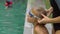 Young woman swimming instructor teach a toddler boy how to swim in a pool