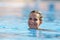 Young woman swimming in the pool on a warm summer day