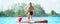 Young woman swimming on stand up paddle board.Water sports , active lifestyle.