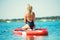 Young woman swimming on stand up paddle board.Water sports , active lifestyle.