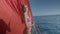 Young woman in swimming suit is relaxing in the sunshine on the sailboat trip