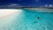 Young woman swimming in tropical lagoon