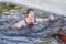 a young woman swims in an ice hole on a winter day, and shows a thumb, excellent