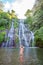 Young woman in swimsuit in front of Banyumala twin waterfalls on Bali