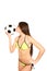 Young woman in a swimsuit holding and kissing a soccer ball on a