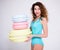 Young woman in swimsuit posing with giant macaroons over gray background