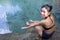 A young woman in swimsuit showing fish