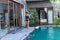 Young woman in swimsuit in swimming pool in gorgeous resort, luxury villa, tropical Bali island, Indonesia.