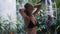 Young woman in swimsuit takes rain shower, tropical greenery on background