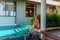 Young Woman in Swimwear Sitting near Swimming Pool on Tropical Luxury Villa