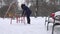 Young woman swing in children playground at winter time. 4K