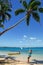 Young woman swinging on a rope swing at Pangaimotu island near T