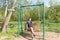 Young woman swinging on a swing. Girl sitting on a swing