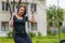 Young woman swinging on swing in the park with copy space. Freedom and happiness concept