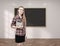 Young woman with tablet and blackboard