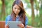 Young woman with tablet computer outdoor