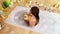 Young woman take bubble bath. Top view