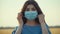 Young woman take off protective medical mask from face and smiling after coronavirus epidemic end