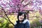 young woman take Outdoor portrait under sakura tree
